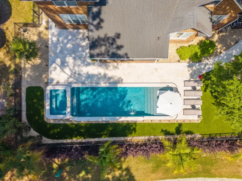A picture of a backyard gunite pool from an aerial view