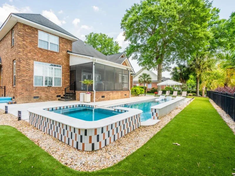 A rectangular gunite pool with varied colors in a pattern format