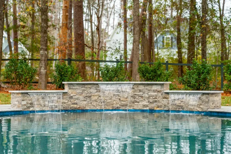 A waterfall on a backyard pool