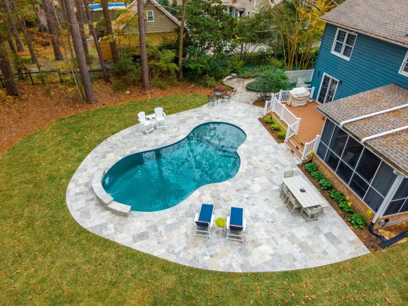 An aerial view of an oblong-shaped gunite pool