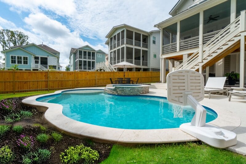 A picture of a gunite pool with a basketball hoop and jacuzzi
