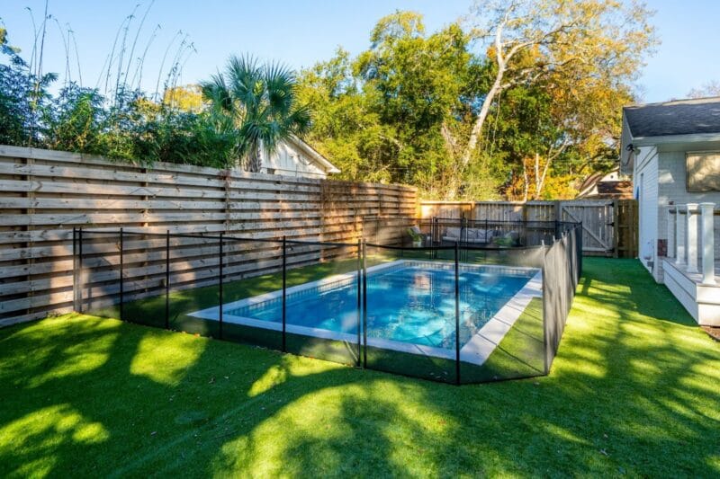 A backyard pool with a fence
