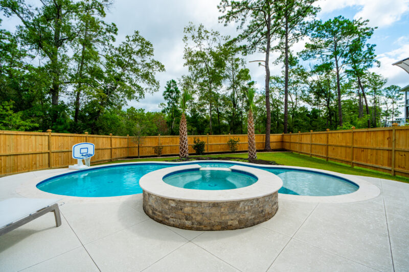 A jacuzzi near a stand-alone gunite pool