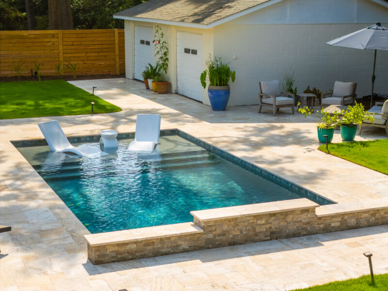 Pool tanning ledges and a backyard pool on display